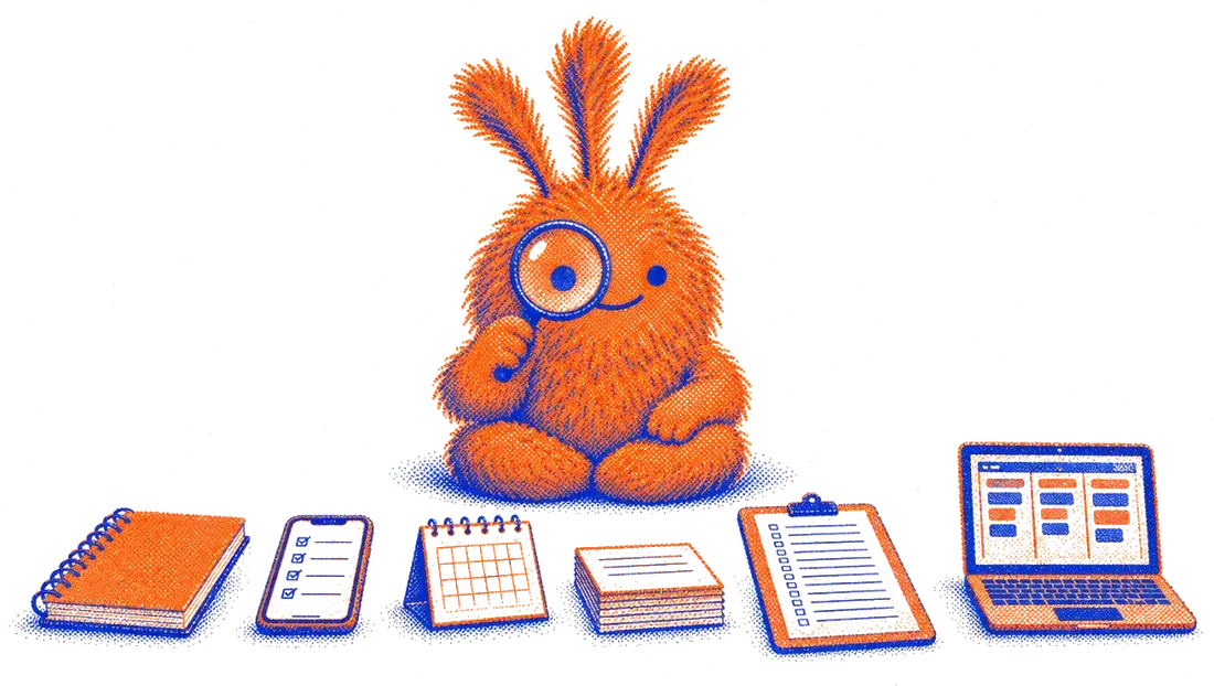 Nuffo, a fuzzy orange monster, inspecting a row of to-do tools with a magnifying glass: a notebook, a phone, a calendar, index cards, a clipboard and a laptop